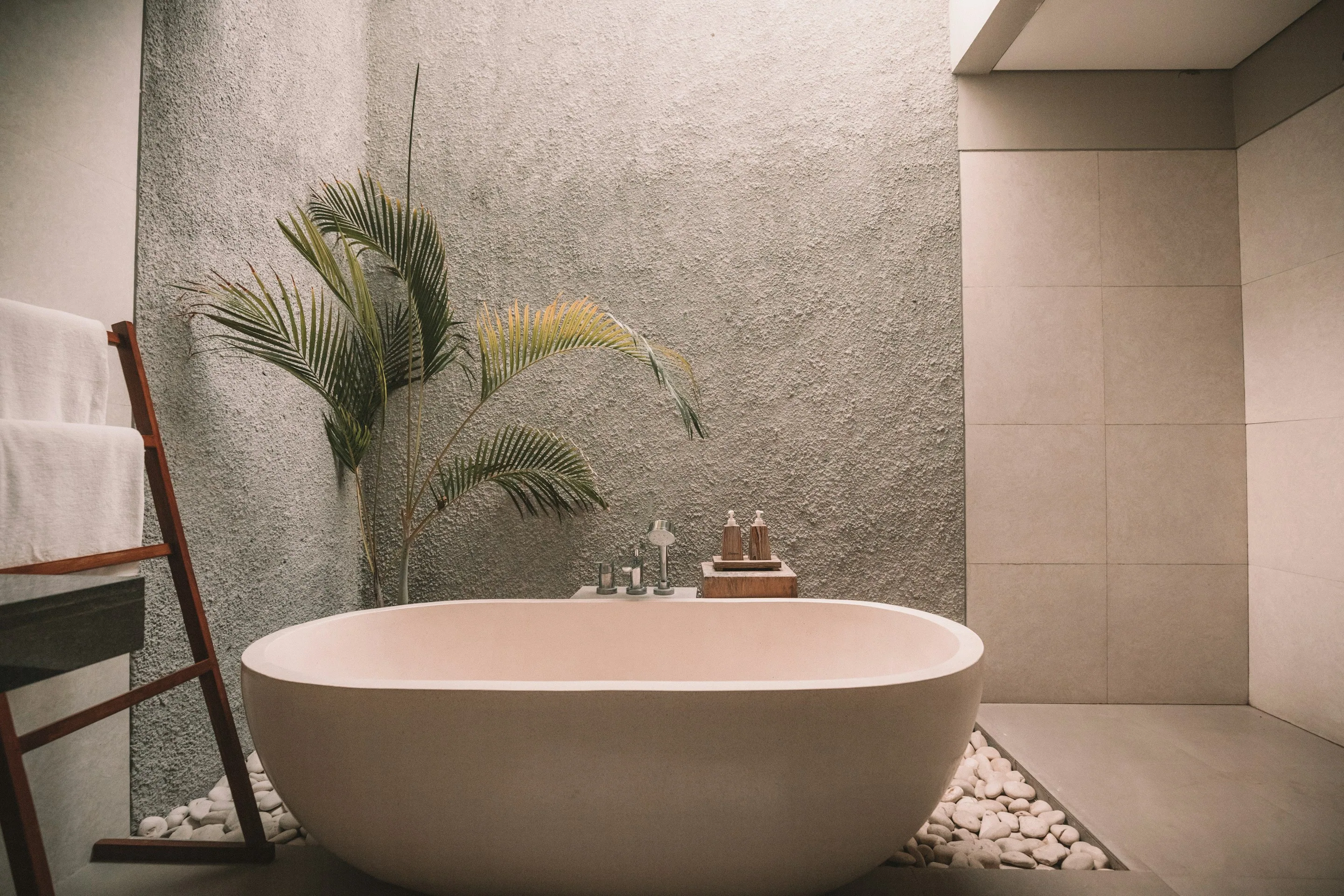 A freestanding bathtub by a window