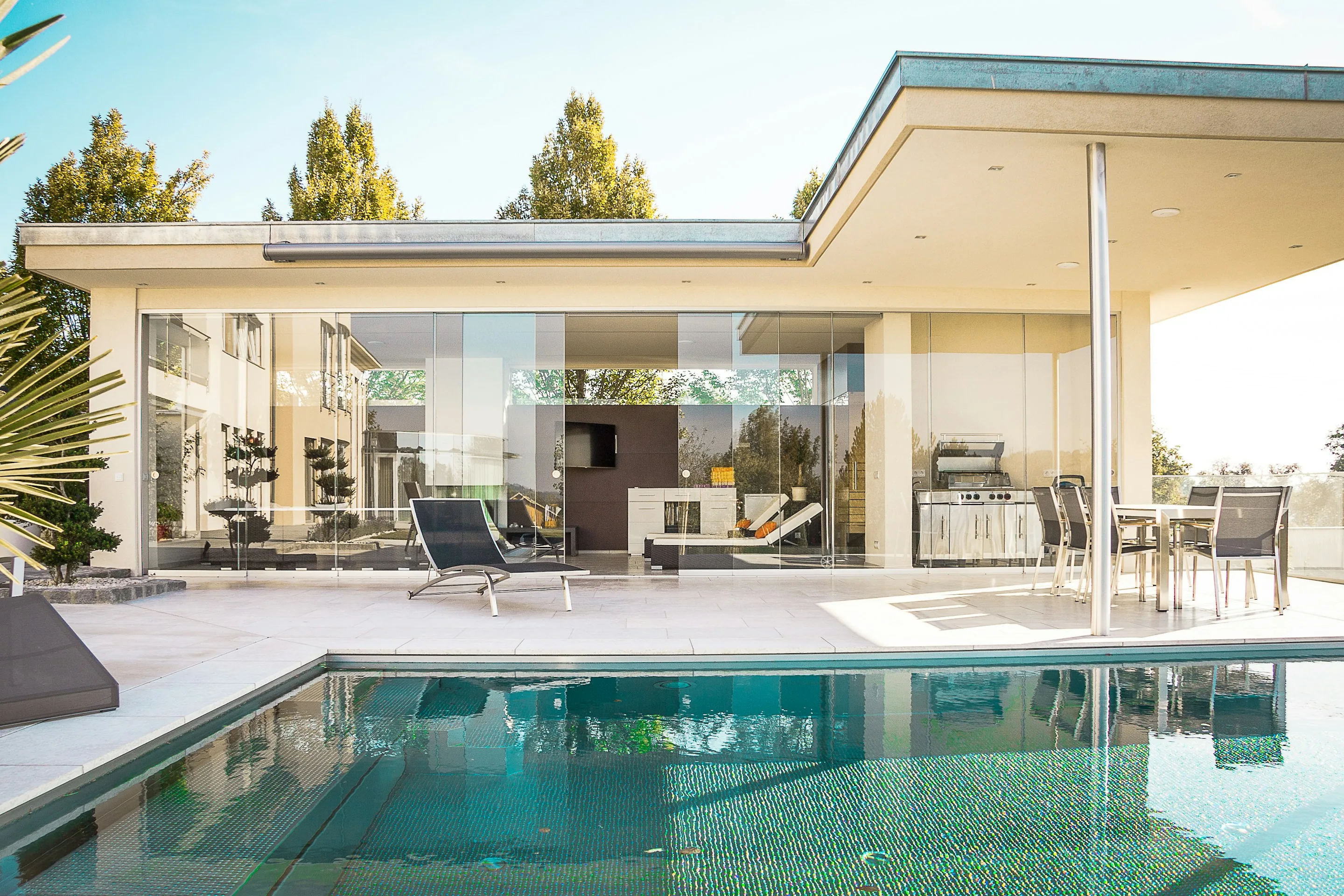 A glass house with a pool