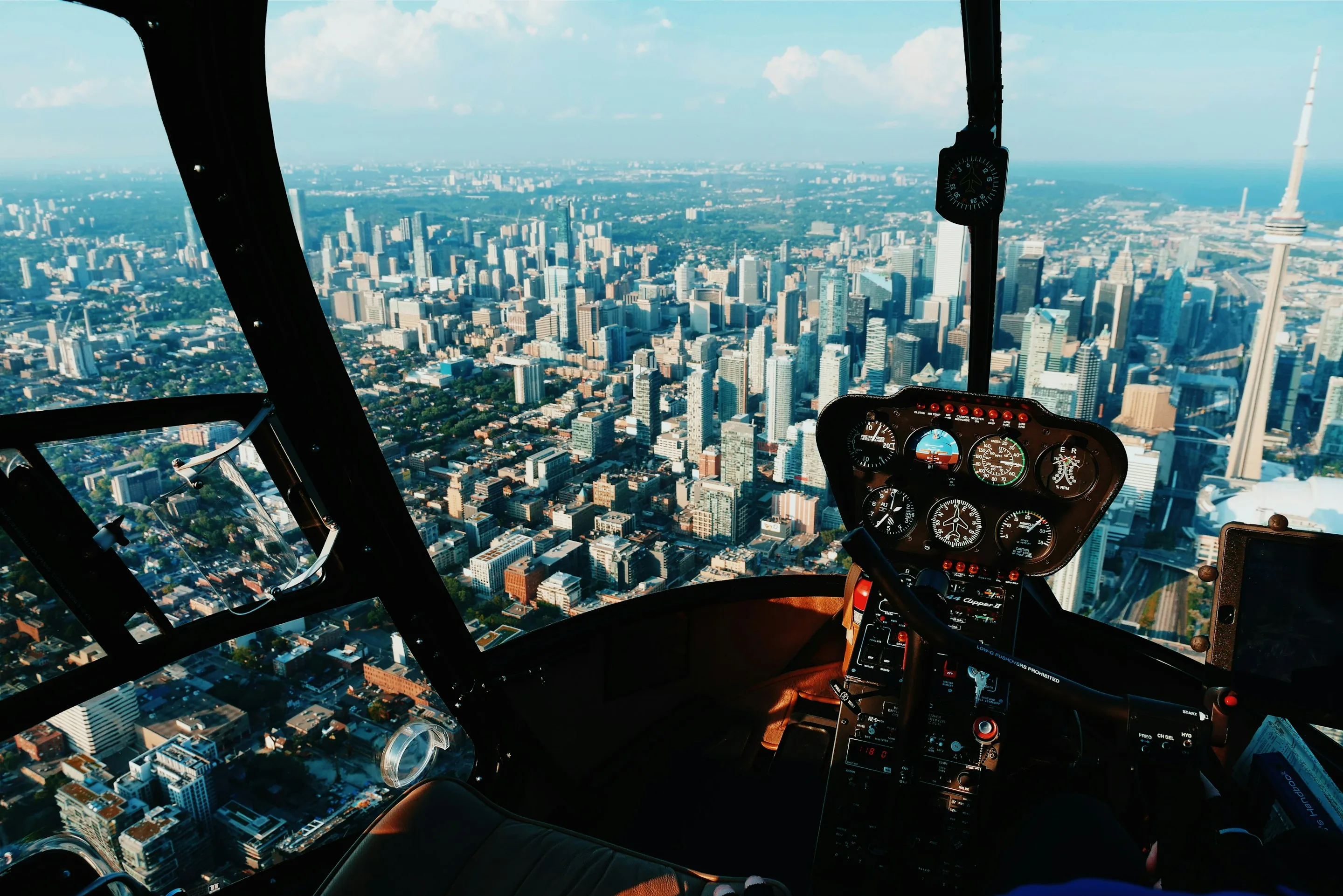 A view over a city from a helicopter cockpit