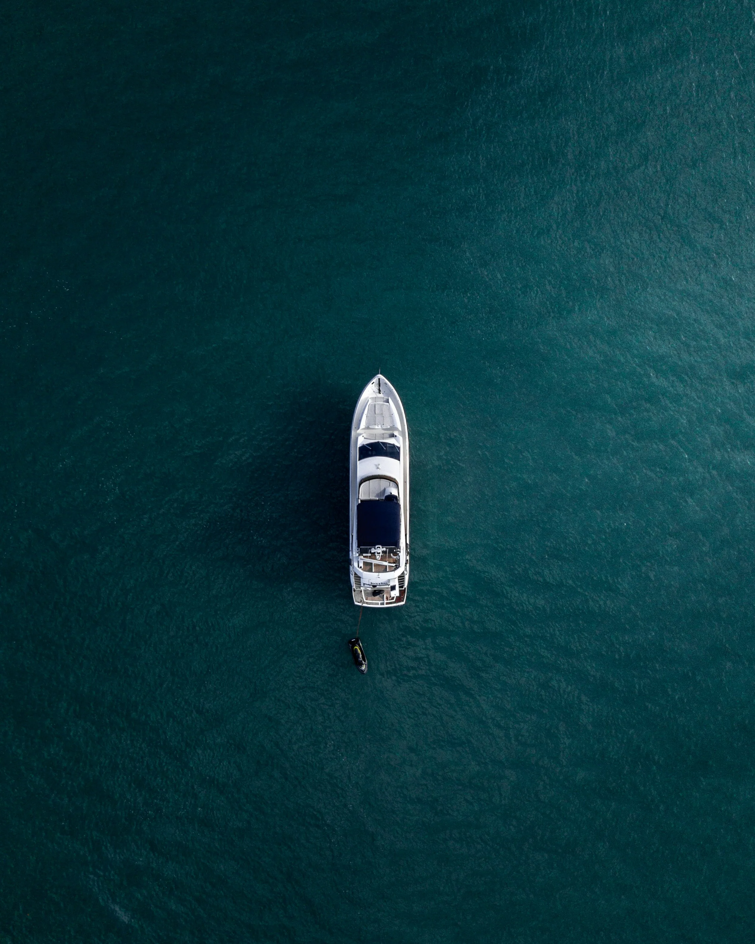 A yacht seen from above on turquoise water